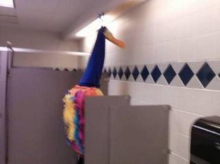 Pointed hat rising from a bathroom stall.