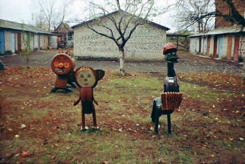 Yard lined with homemade Halloween figures.