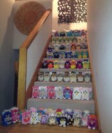 A staircase is packed with rows of plush toys and faces.