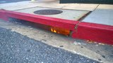 A small flame appears along a curb or street edge.