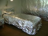 Furniture wrapped completely in silver foil.