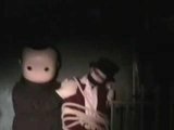 two small figures posed in darkness.